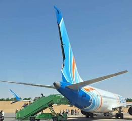 Passengers leave flydubai Flight FZ1073 by the rear stairs at Tabuk, Saudi Arabia, on Wednesday