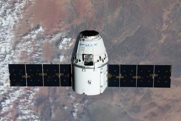A SpaceX Dragon spacecraft in orbit above the Earth